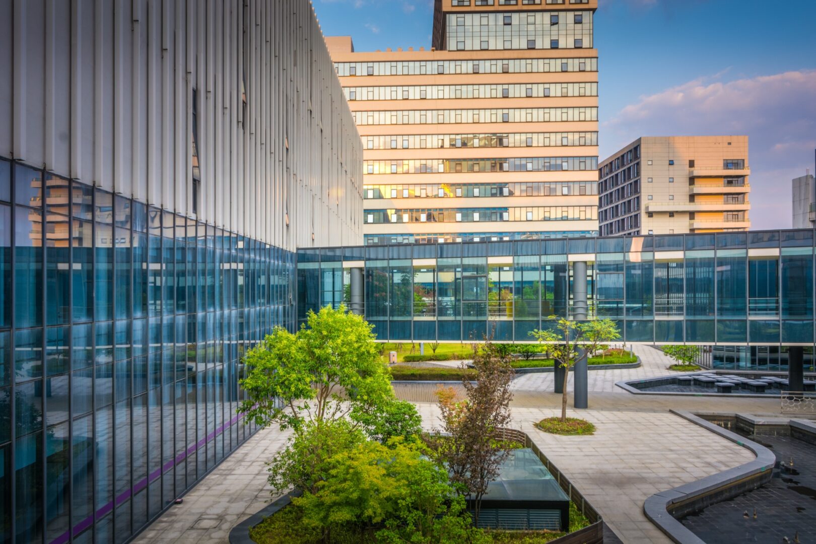 A building with glass windows and a garden in the center.