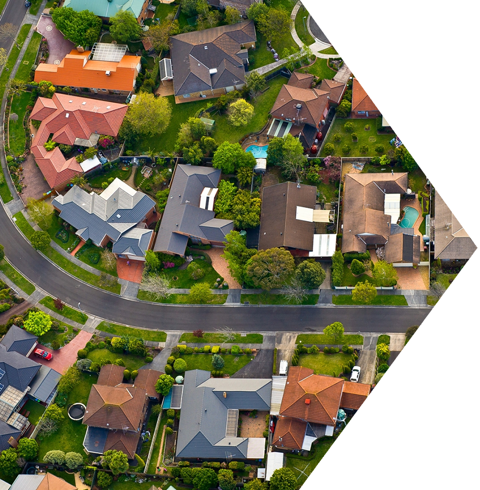 A green aerial view of houses in the suburbs.